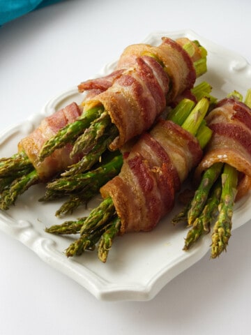 bacon wrapped asparagus on a platter.