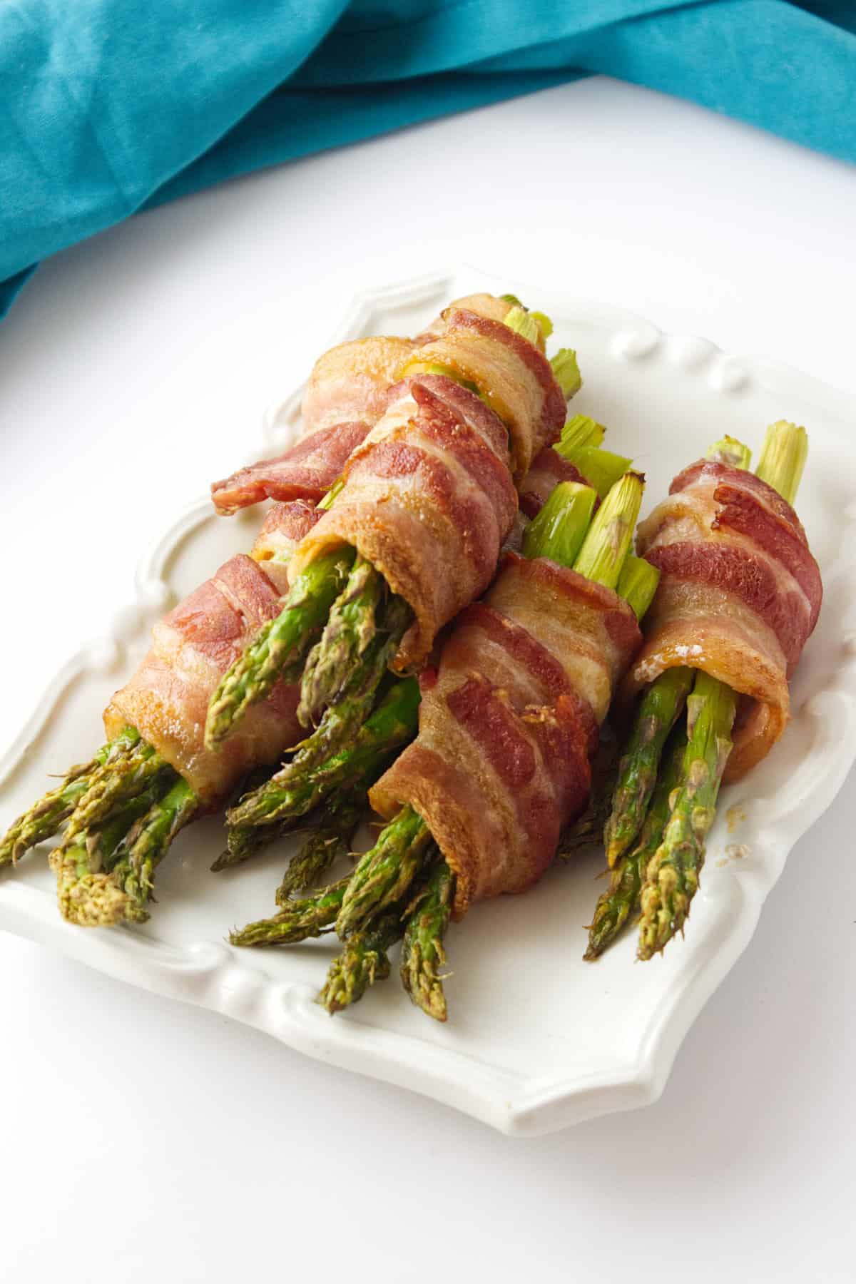 bacon wrapped asparagus on a platter.