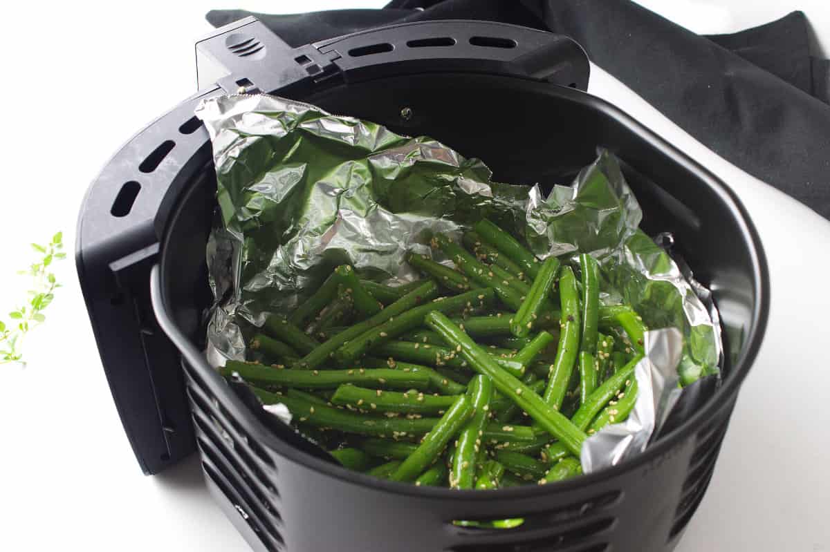 basket loaded with veggies for air frying.