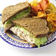 chicken salad sandwich on a plate with chips.