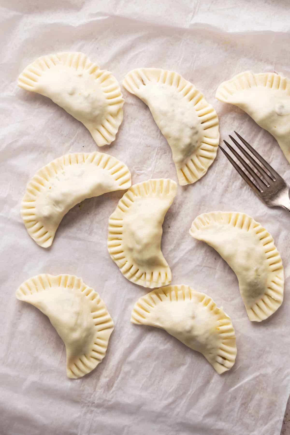 crimped edges of small meat pies.