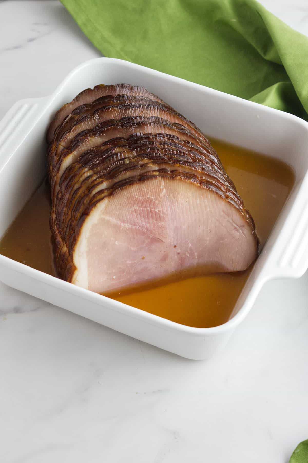 cooked ham in a baking dish.