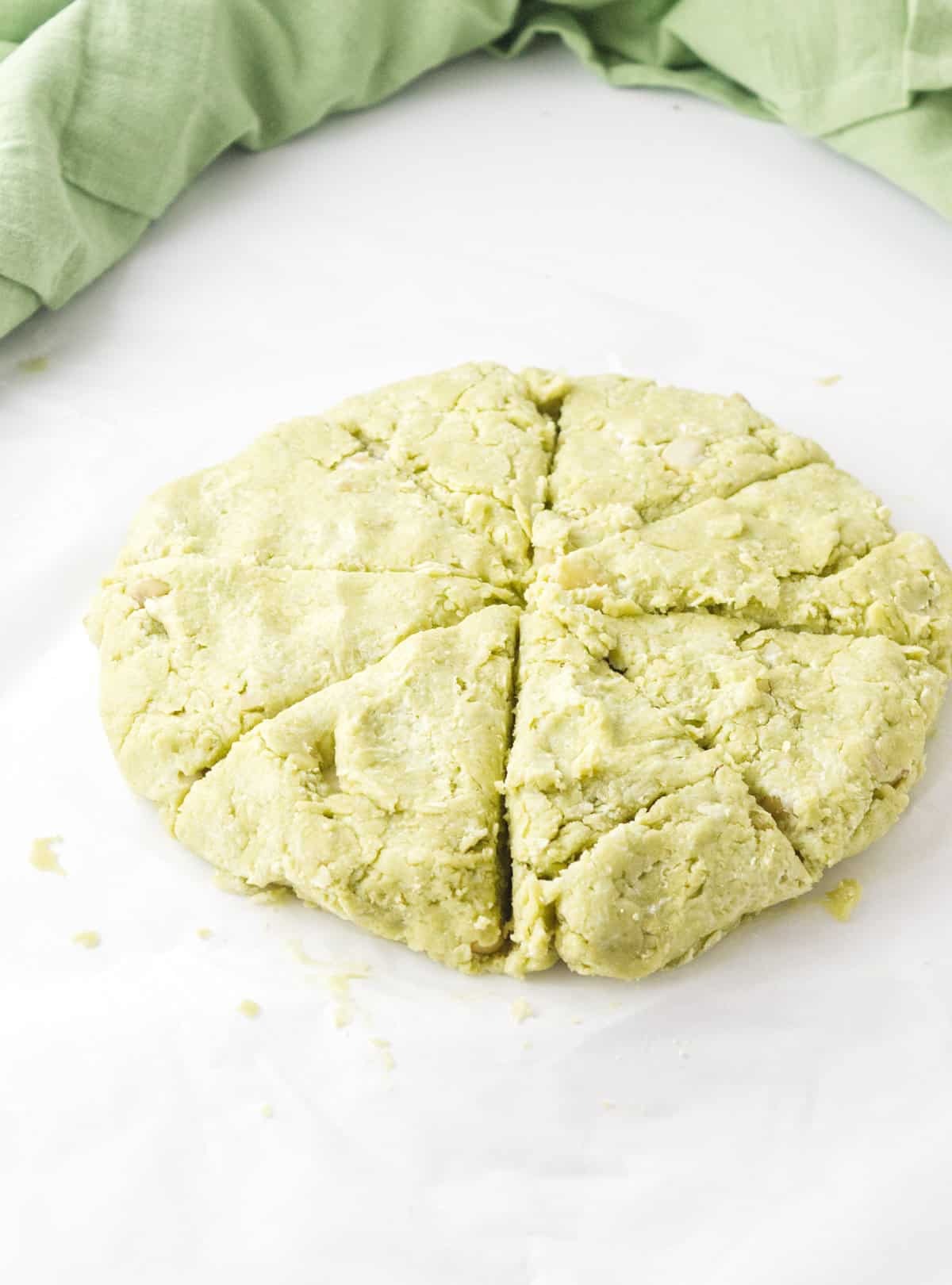disc of green dough cut into 8 wedges.