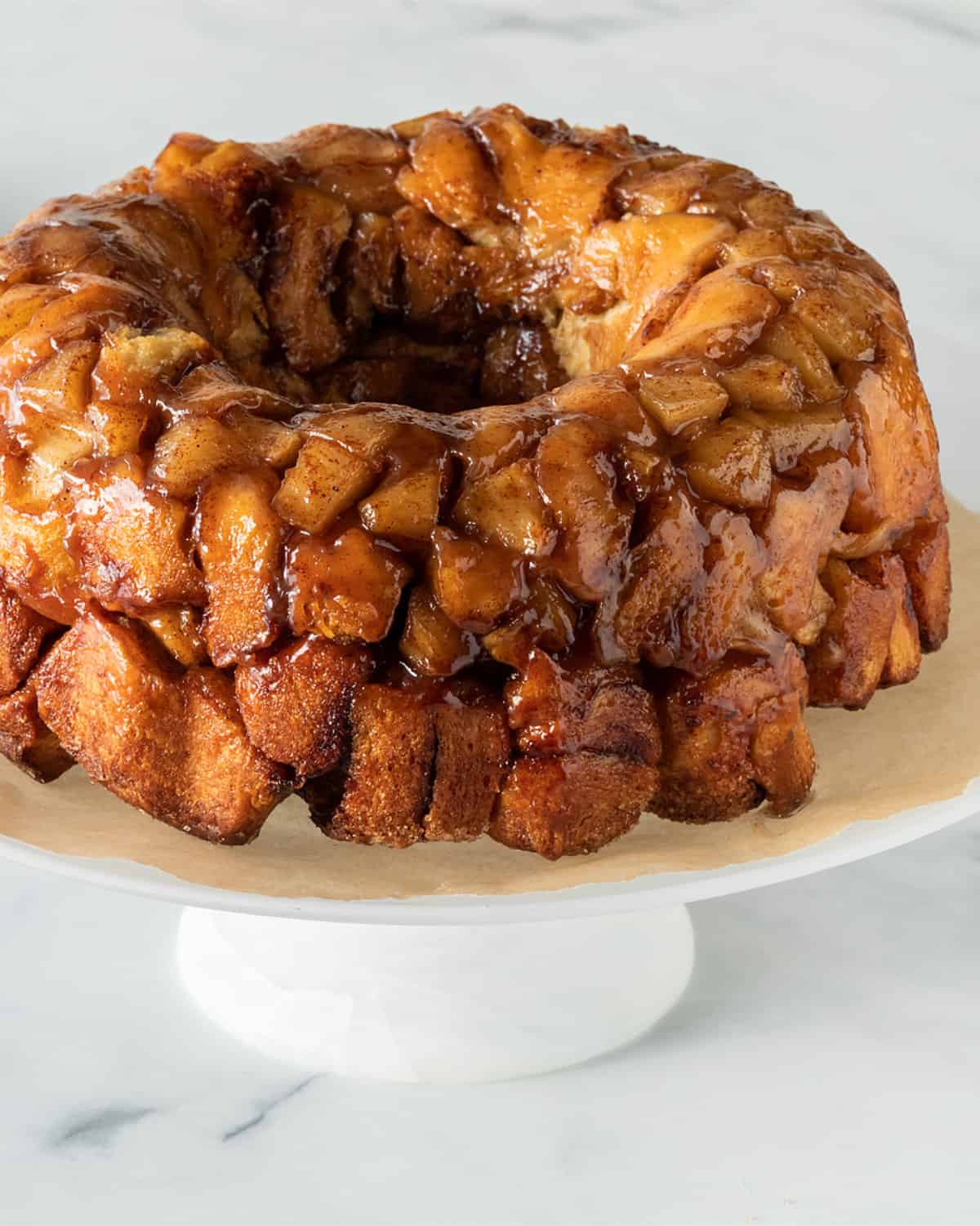 unfrosted monkey bread on a cake stand.