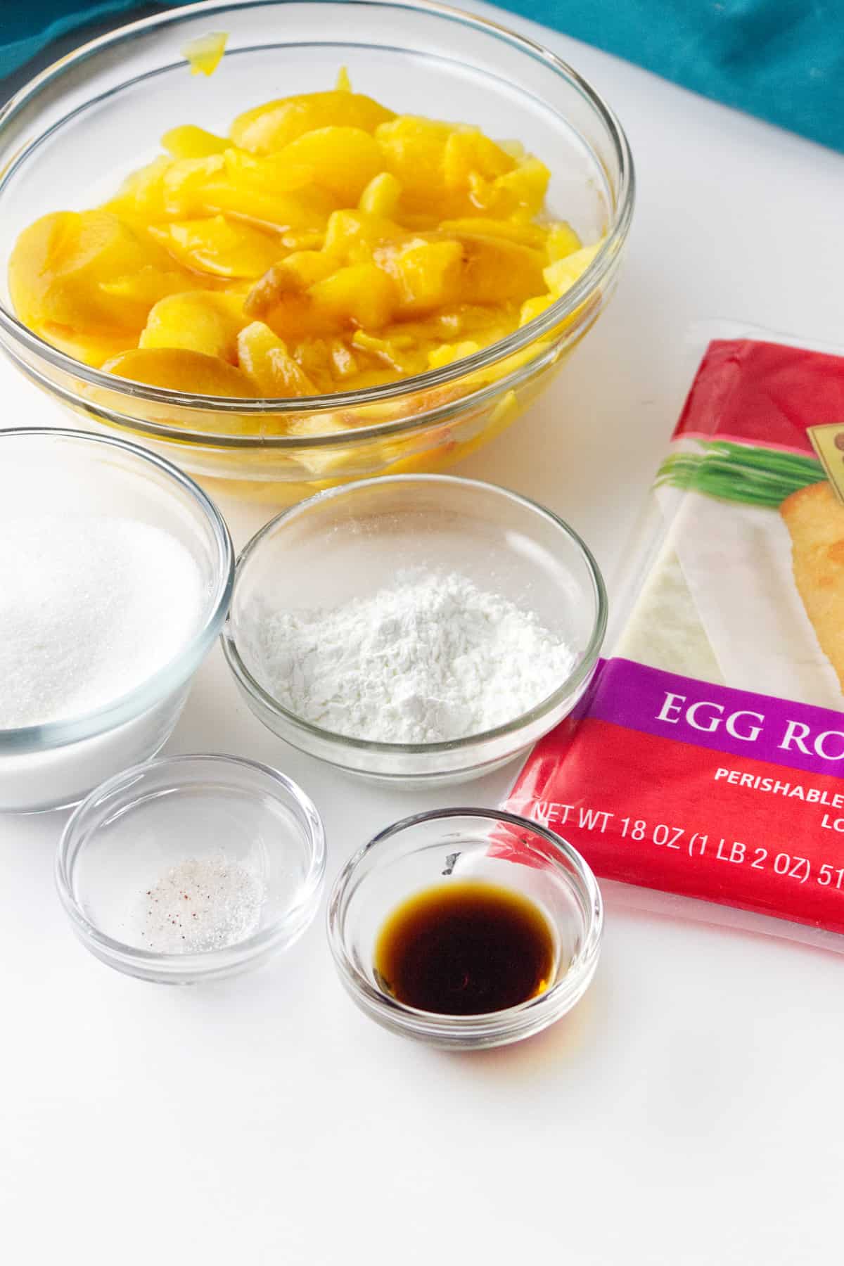 ingredients for making peach cobbler egg rolls.