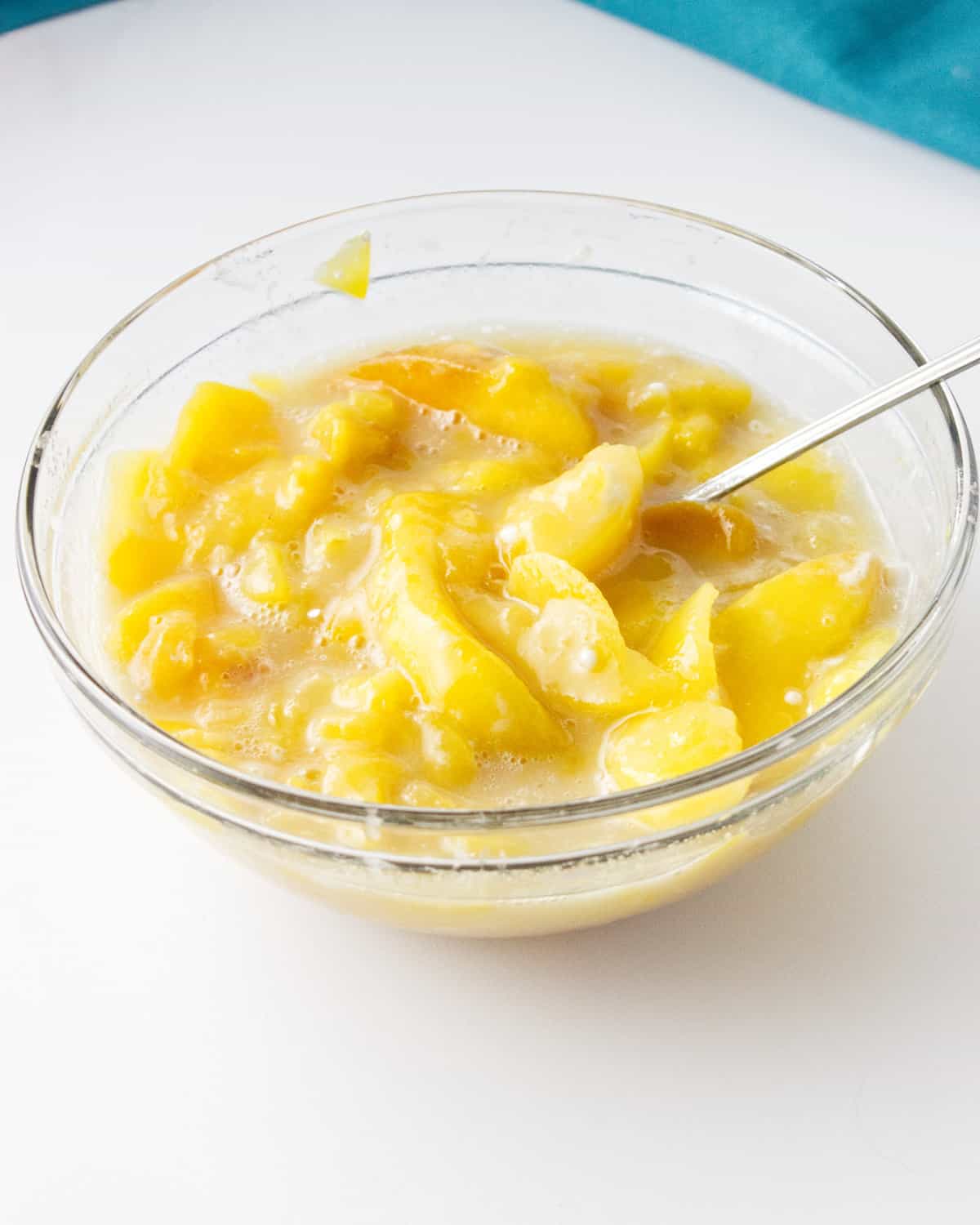 bowl of peaches mixed with sugar and cornstarch.