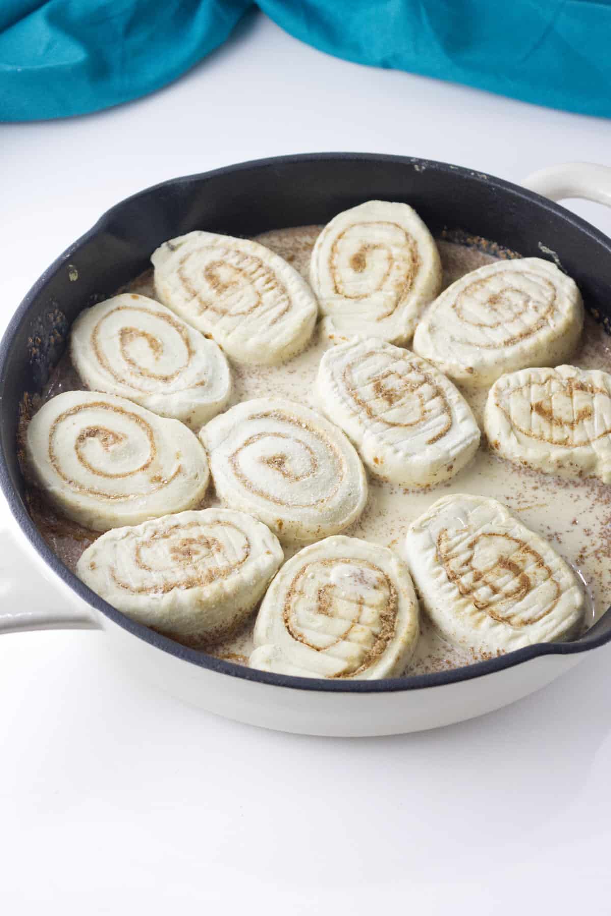 frozen cinnamon rolls in pan with heavy cream.