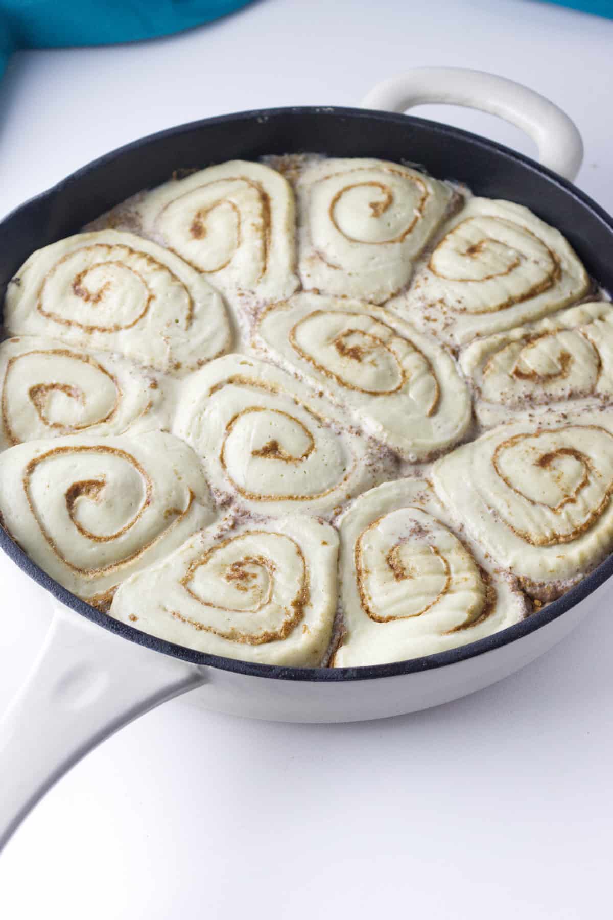 pan of risen cinnamon rolls.