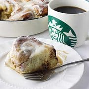 plate with cinnamon roll and cup of coffee.