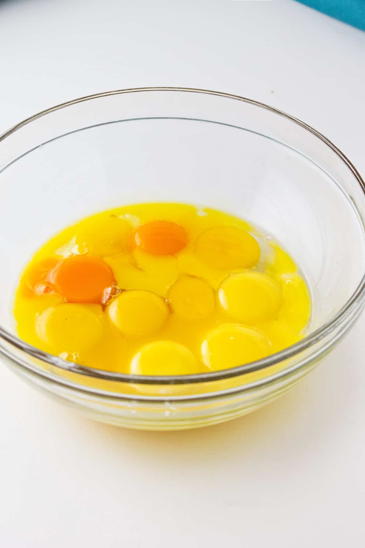 a dozen egg yolks in a bowl.