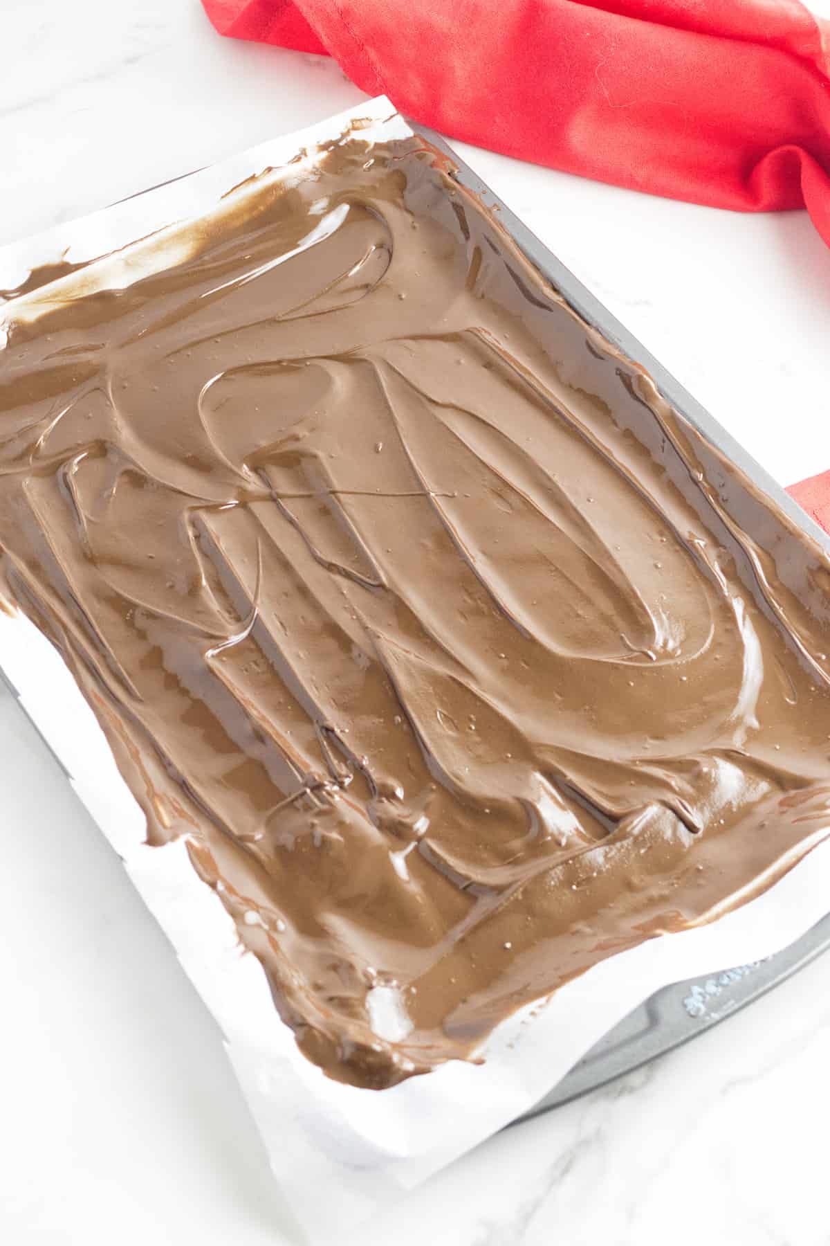 milk chocolate spread out on a cookie sheet.