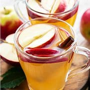 apple juice in a glass with apple slices.