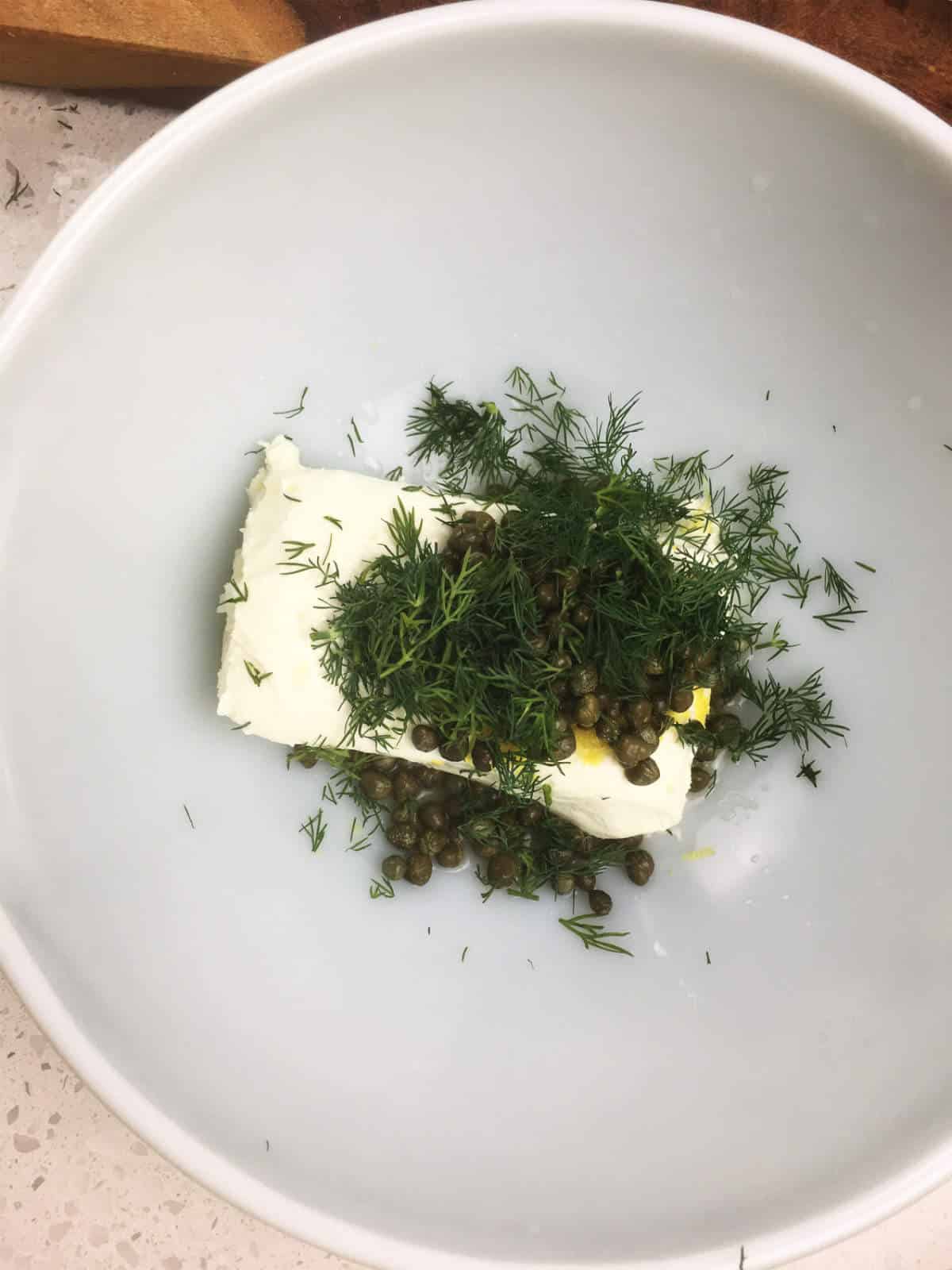 dill weed and cream cheese, and capers in a bowl.