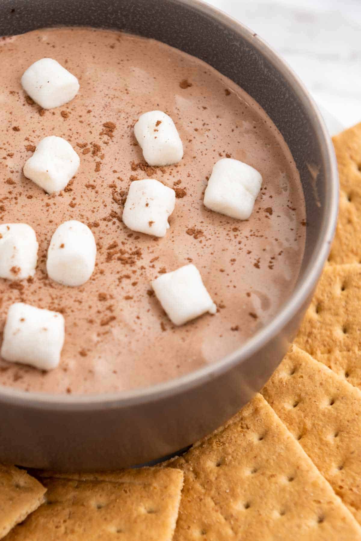 marshmallow fluff chocolate cookie dip with mini marshmallows and graham crackers.