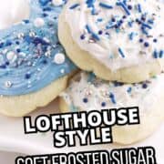 Four soft almond sugar cookies with thick blue and white frosting, topped with blue and white sprinkles, are stacked on a white plate. Text reads: “Lofthouse Style Soft Frosted Sugar Cookies.”.
