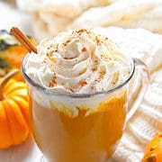 Pumpkin spice chai latte in a mug with whipped cream.
