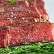 sliced ribeye steak on a platter.