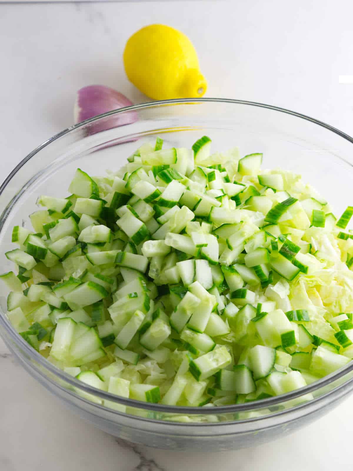 chopped cabbage and cucumber in a large bowl.