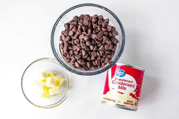ingredients for 3 minute fudge: semi sweet chocolate chips, butter cubes, and sweetened condensed milk.