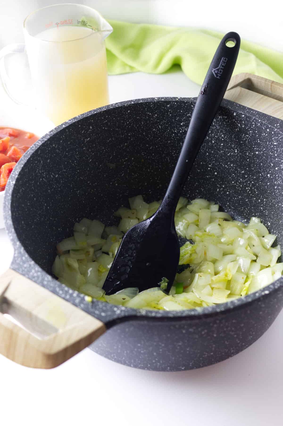 sauteing onions in a soup pot.