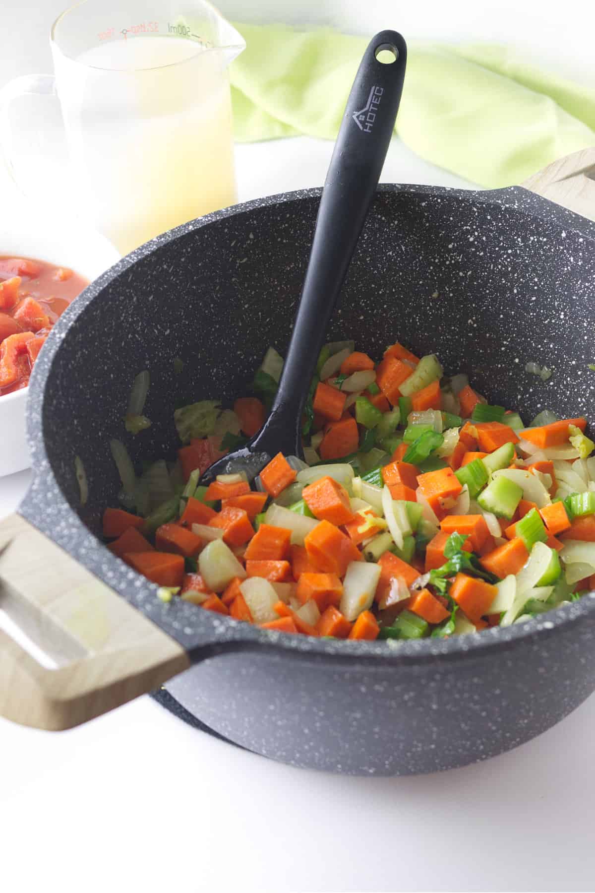 sauteing soup vegetables in a pot.
