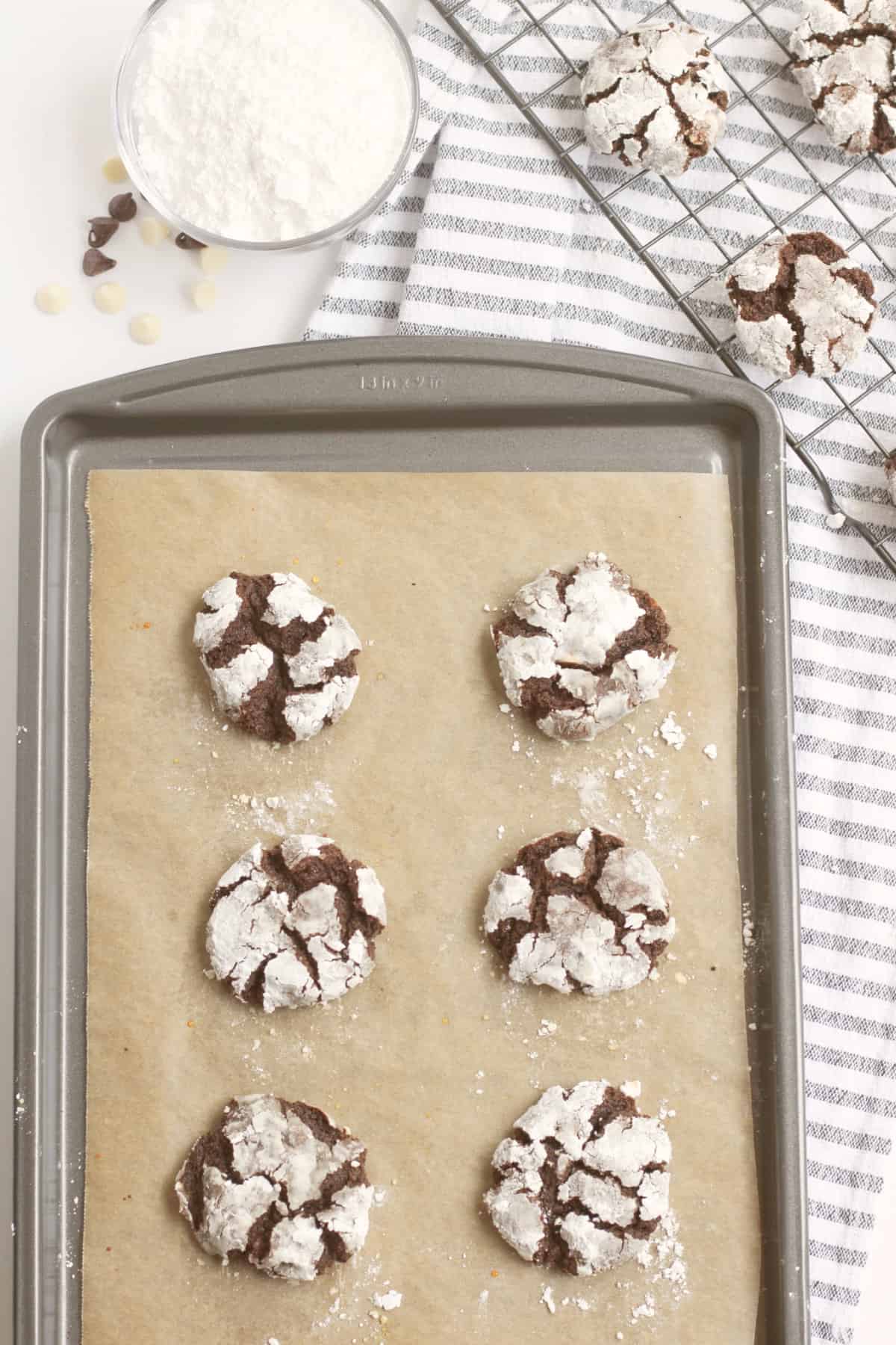 baked crinkle cookies on a cookie sheet.