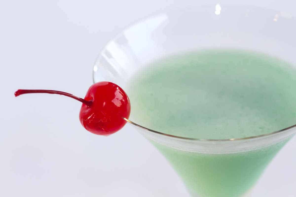 creme de menthe Grasshopper martini with a maraschino cherry garnish.