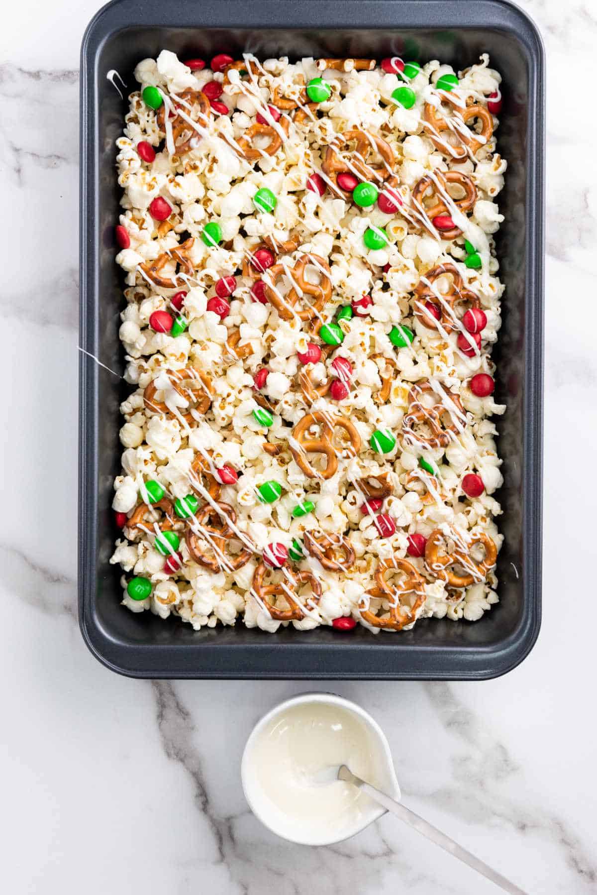 white chocolate drizzled over popcorn, pretzels, and holiday m&m's.