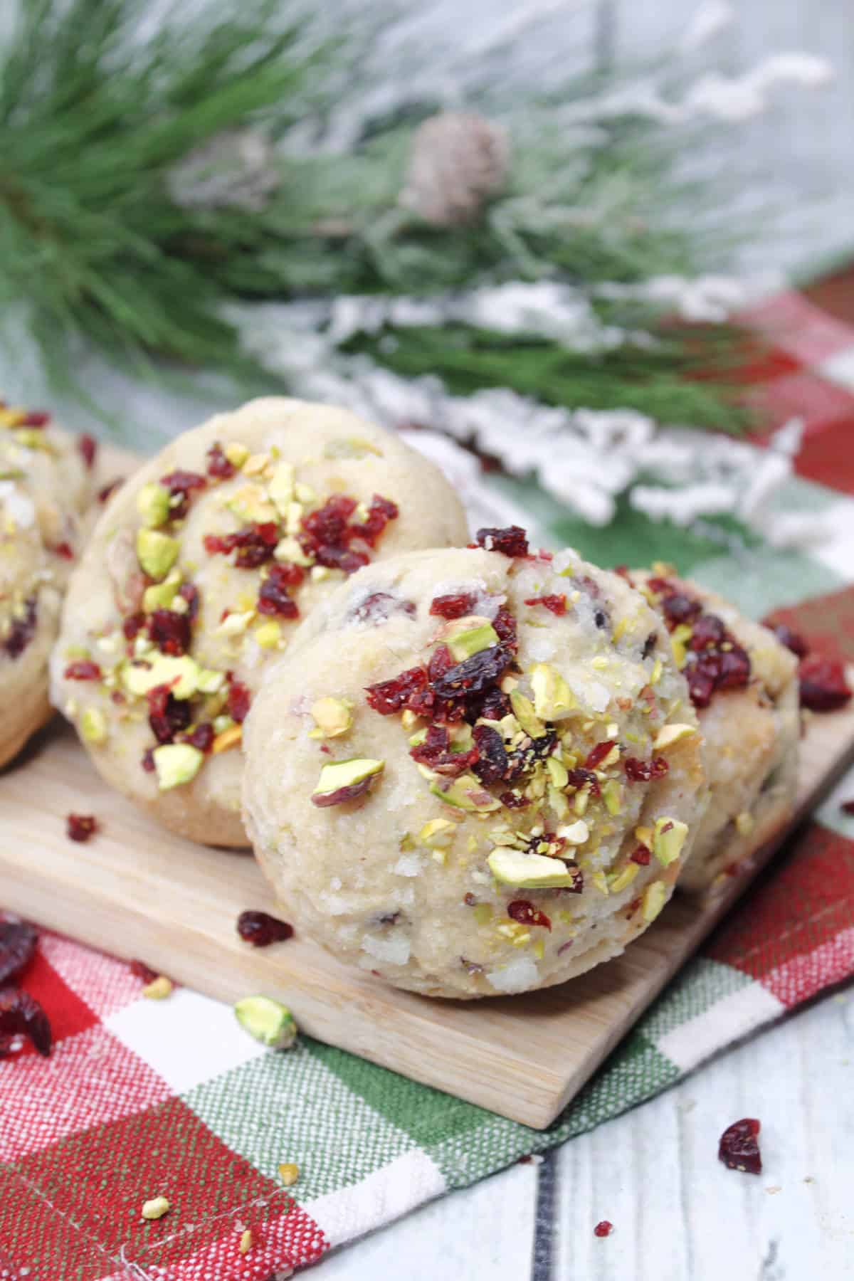 shortbread cookies with pistachios and cranberries on plaid napkin.