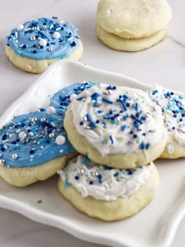 Close up of soft frosted sugar cookies with thick pink frosting.