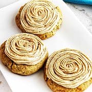 swirl frosted cinnamon cookies on a plate.