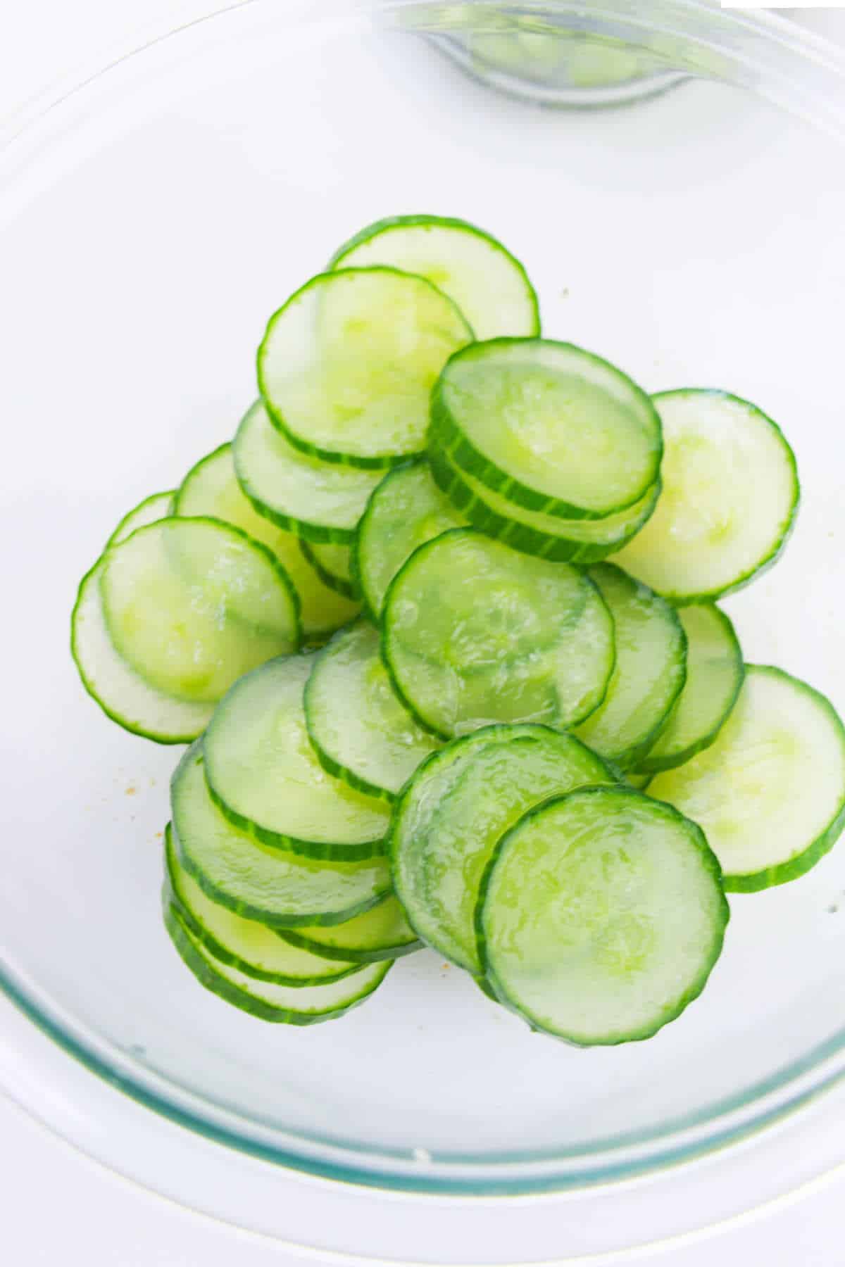 salted cucumbers wilting in a bowl for a salad.