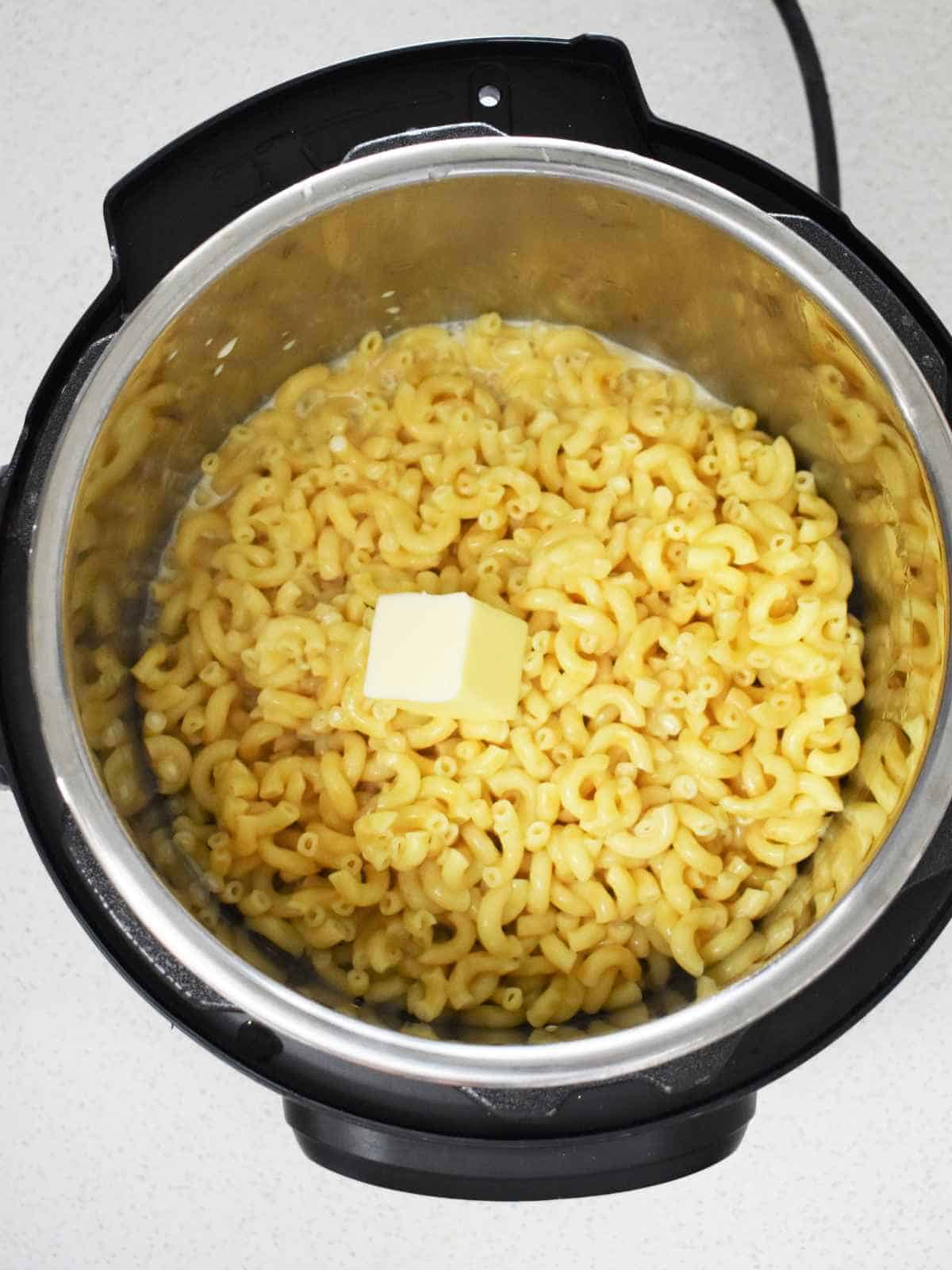 milk and butter added to elbow macaroni in an instant pot.