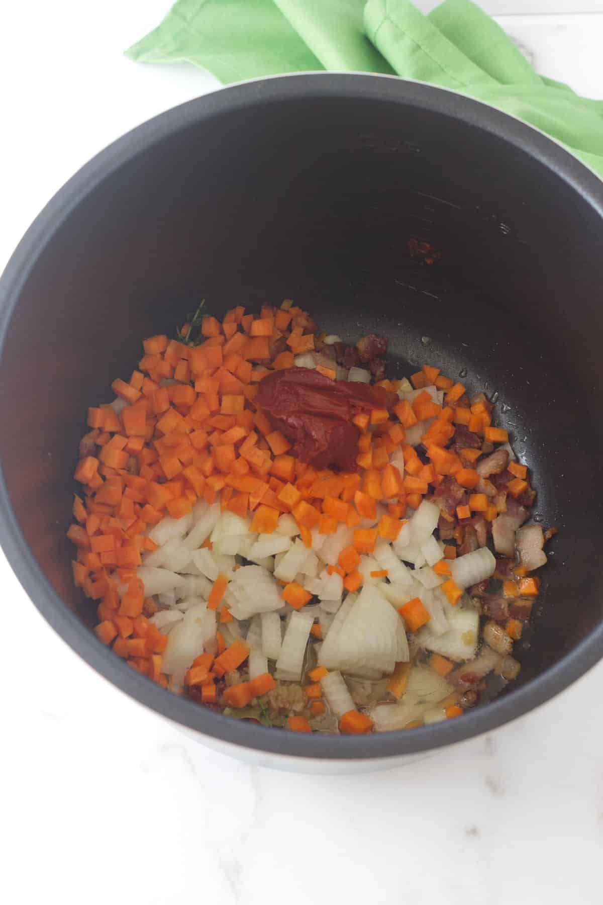 vegetables, seasonings, and onion in an instant pot to saute.