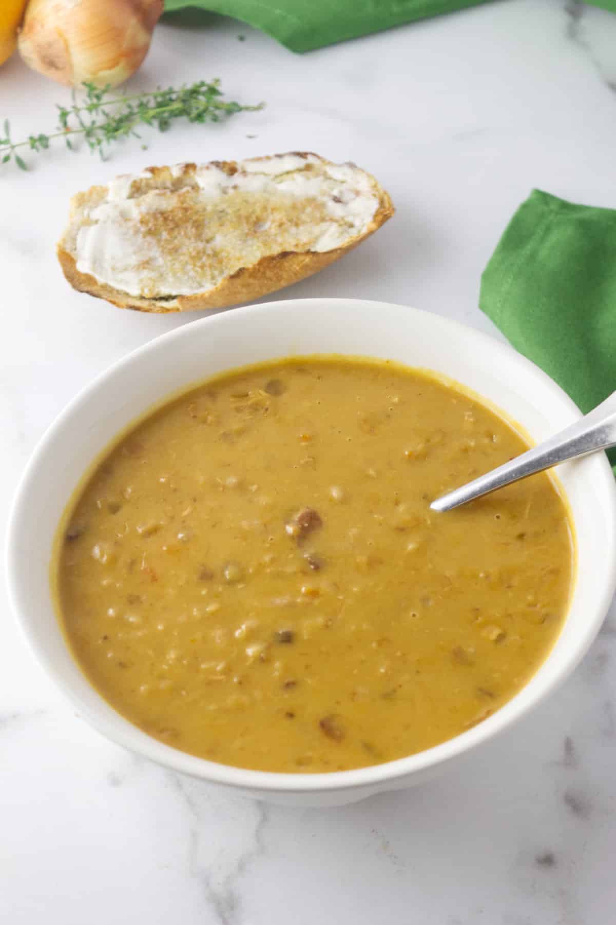 Instant Pot copycat Campbells Bean and Bacon soup with toast nearby.