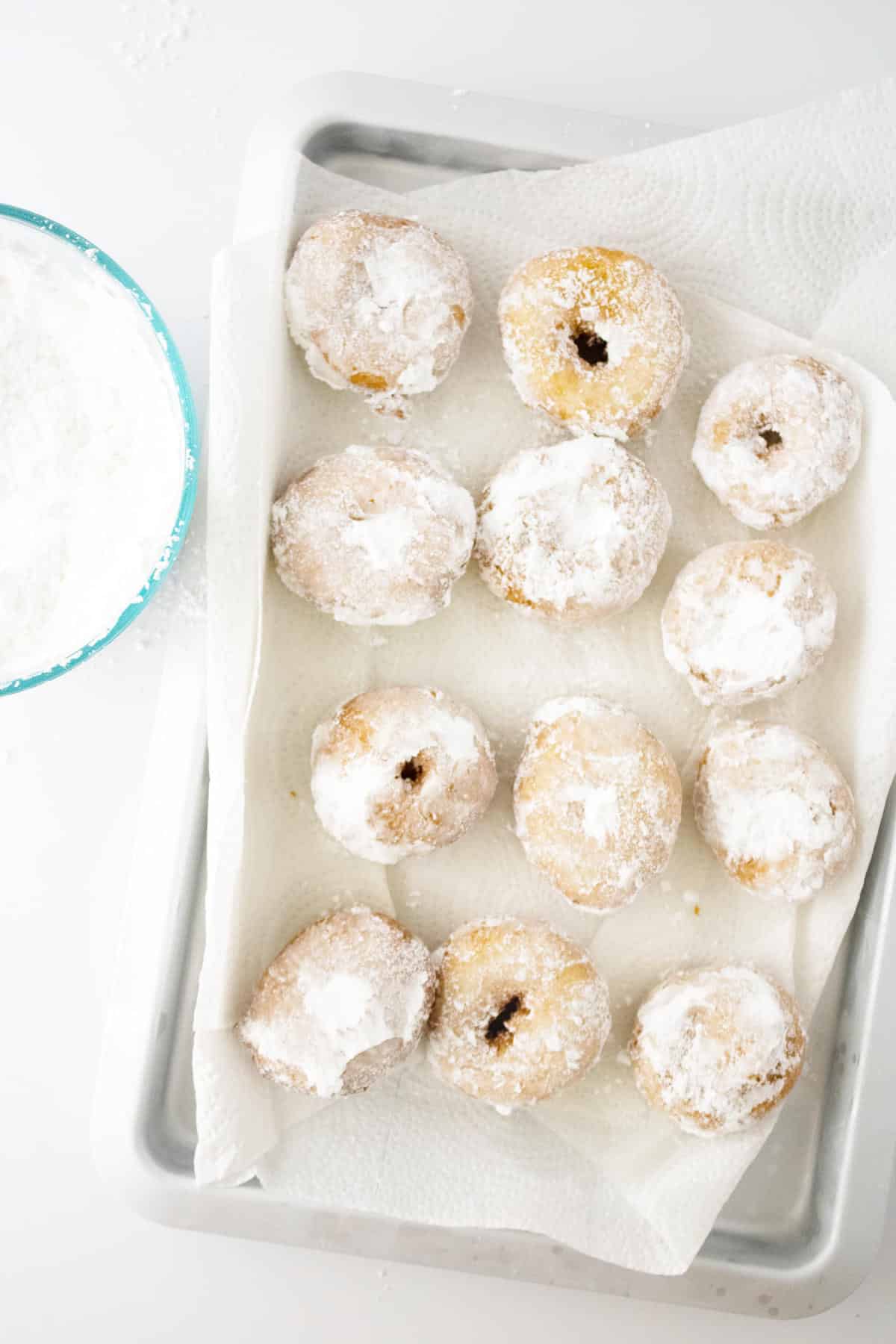 mini donuts covered in powdered sugar.