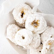 mini little debbie powdered sugar donuts in a bowl.