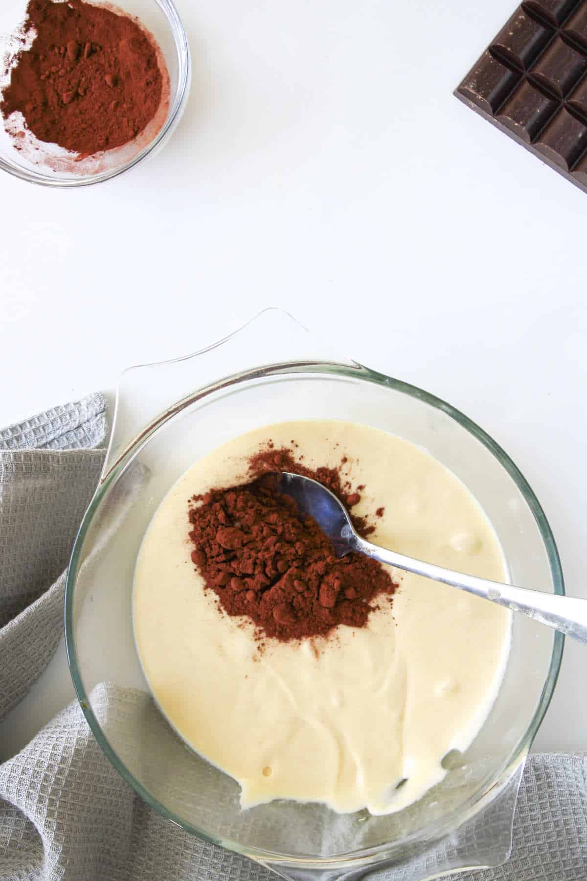 adding cocoa to vanilla cake batter.