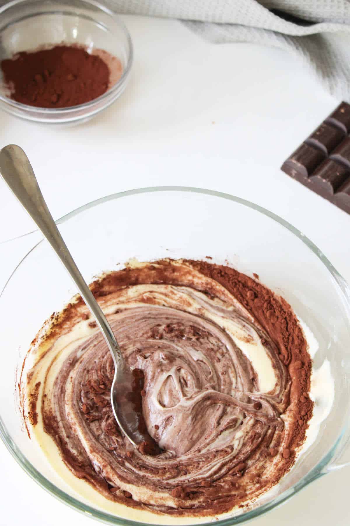 blending in melted chocolate into part of the cake batter.
