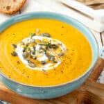 Panera's Autumn Squash soup with pepitas and sour cream swirl in a bowl.