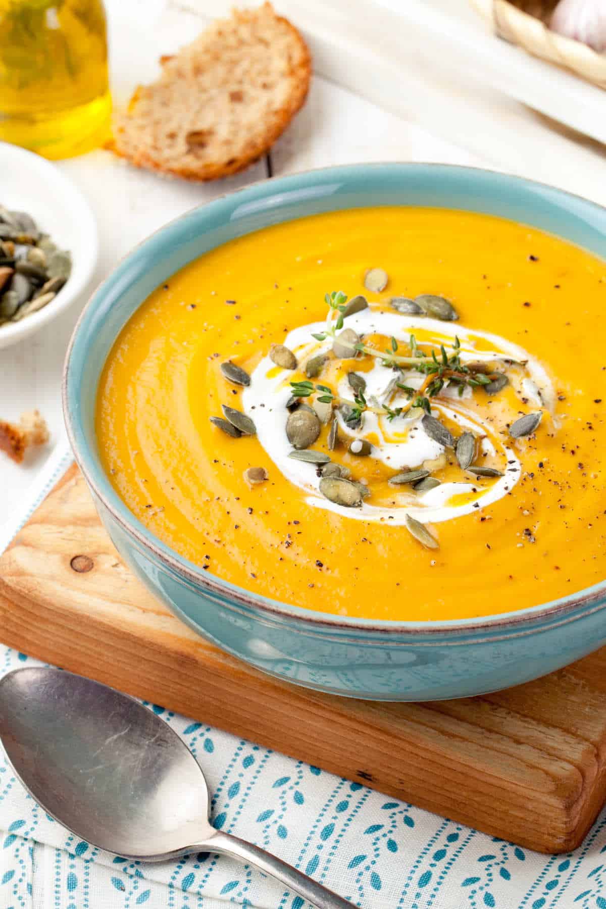 Panera Autumn Squash soup with pepitas and sour cream swirl in a bowl.