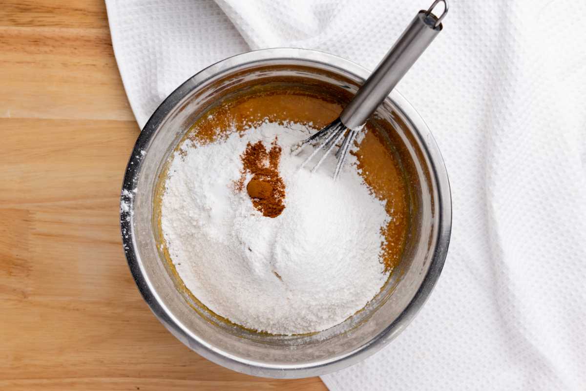flour, baking powder, and cinnamon added to wet pumpkin puree mixture.