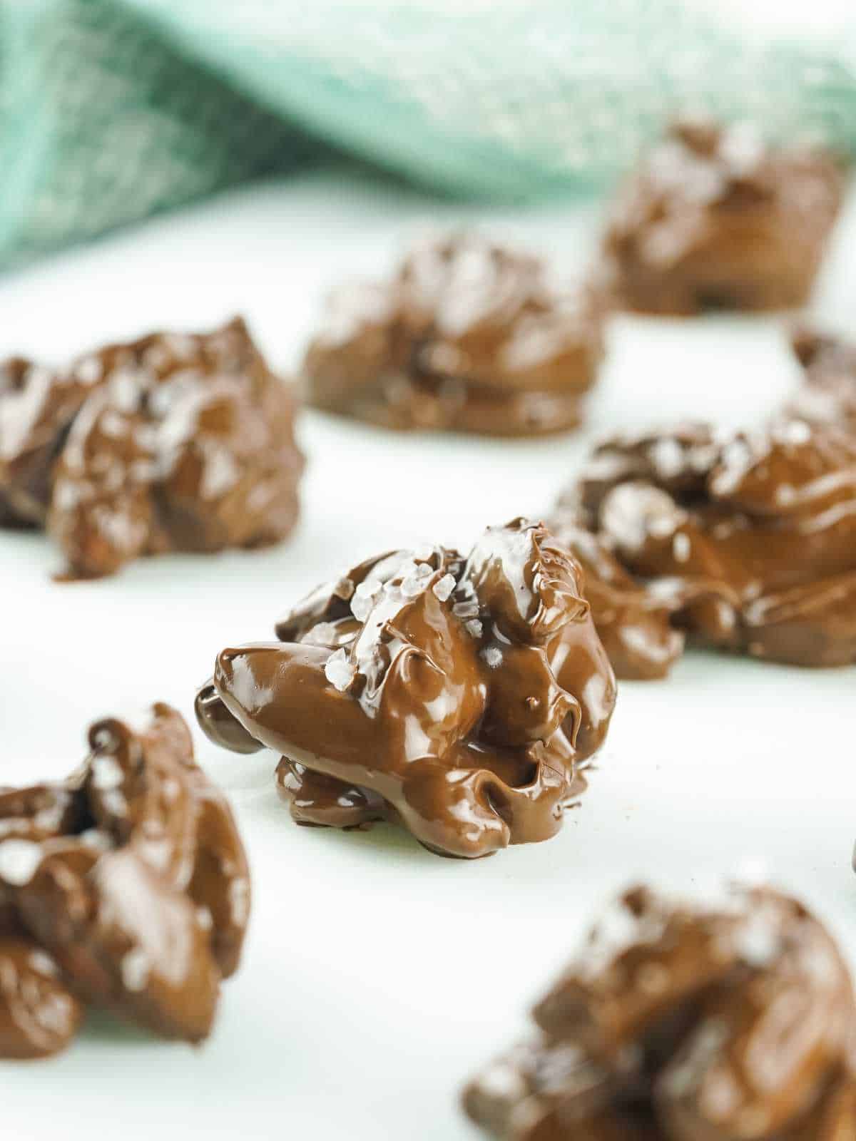 rows of chocolate candies  firming up on parchment paper.