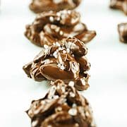 rows of sea salt chocolate almond clusters firming up on parchment paper.