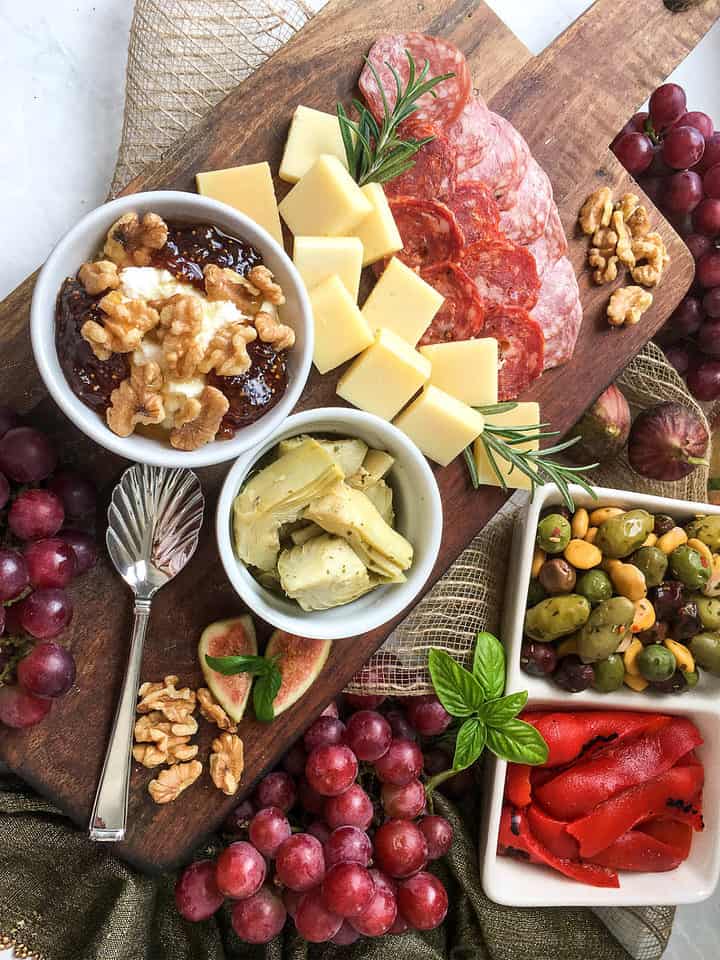ingredients to make a platter of Italian antipasto of meat and cheese.