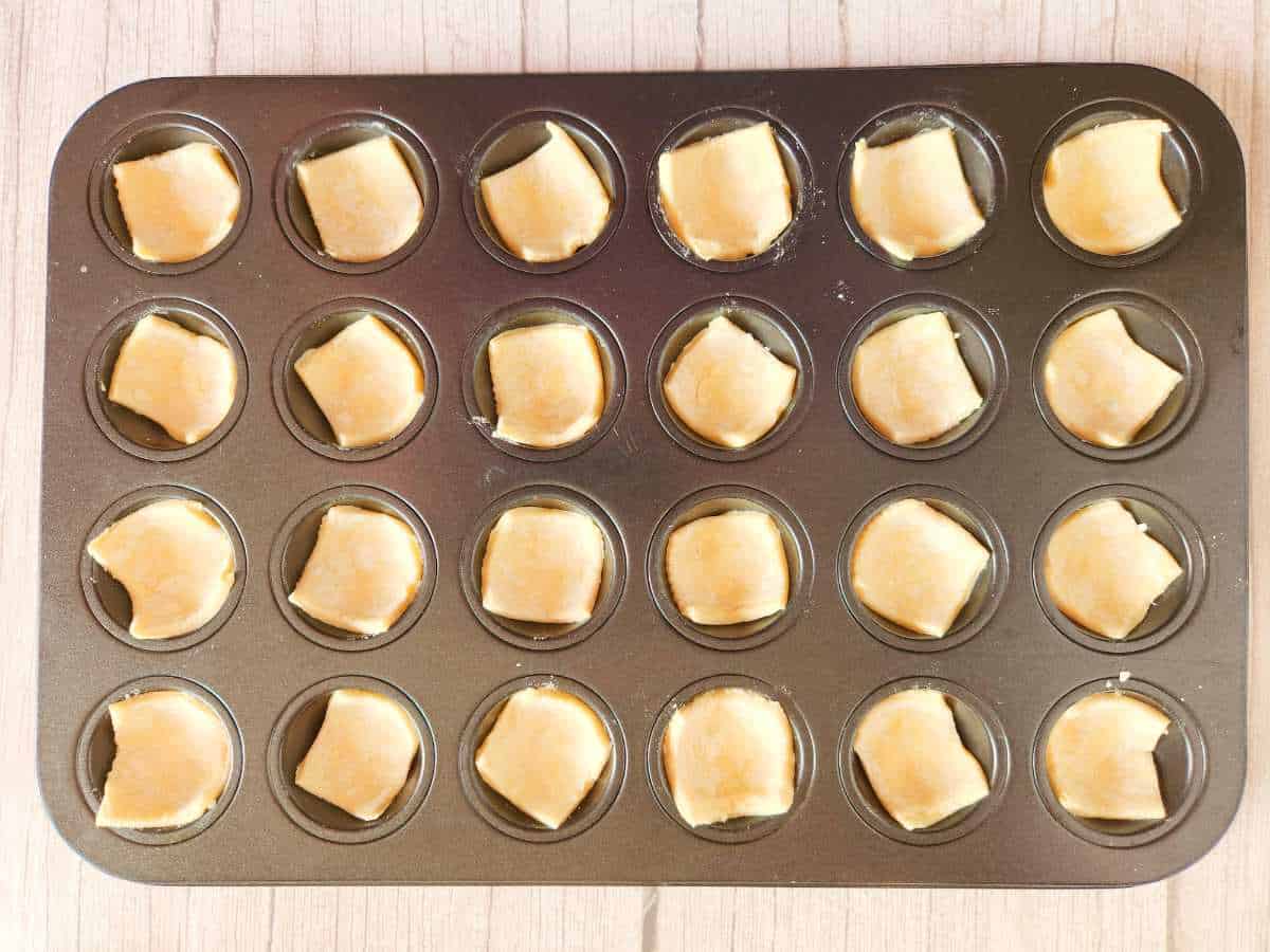 puff pastry squares pressed into mini muffin tin cavities.