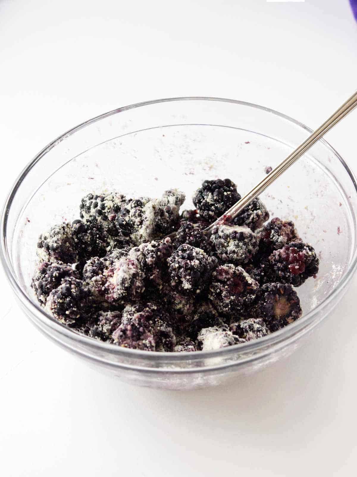 berries in a bowl tossed with flour.