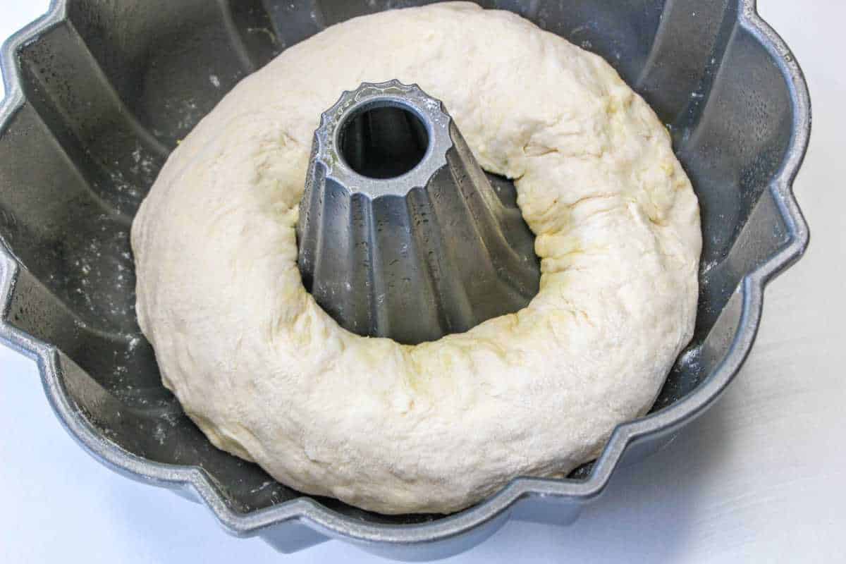 bread dough proofing in a bundt pan.