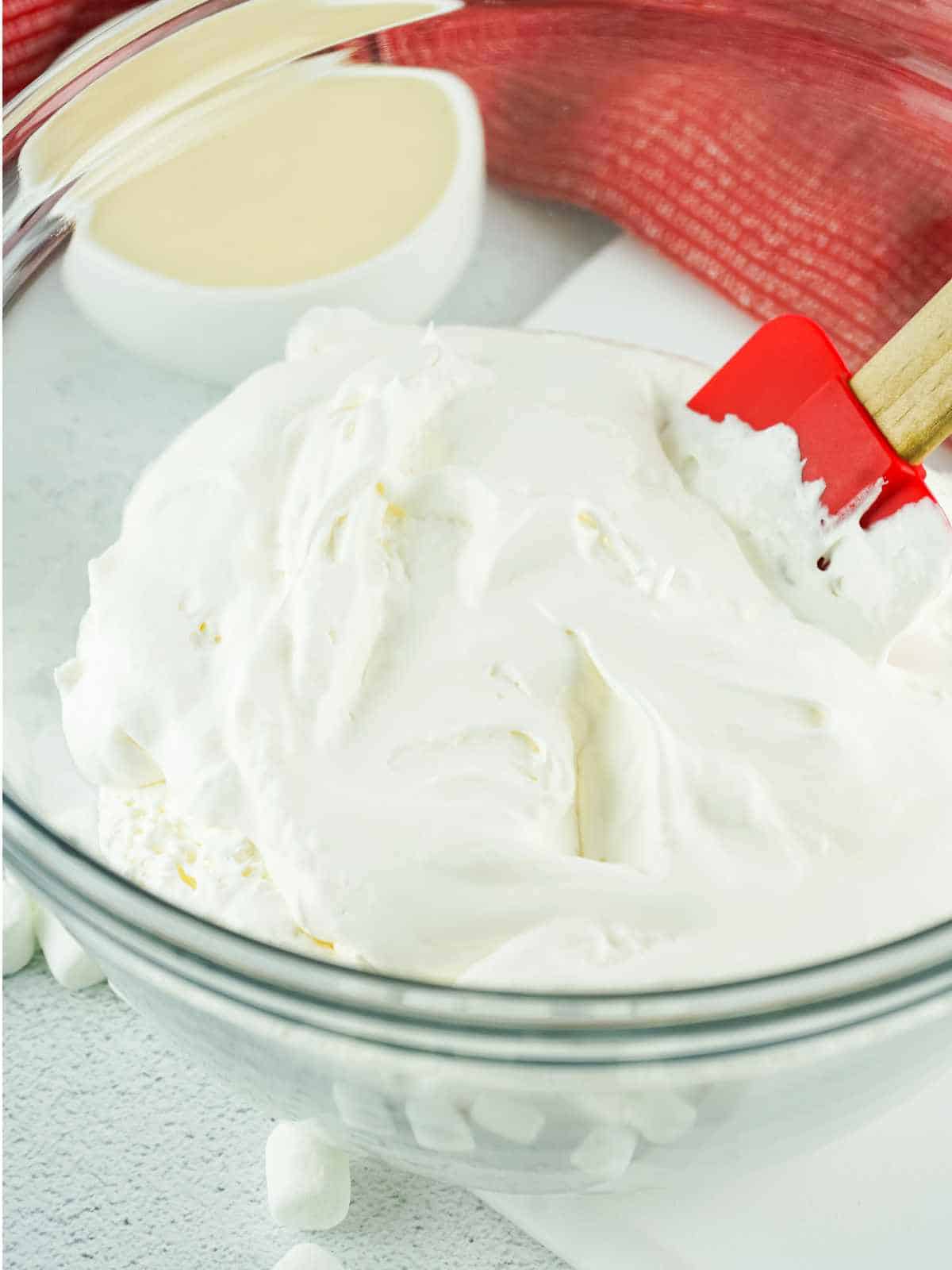 mixing whipped cream with shredded coconut.