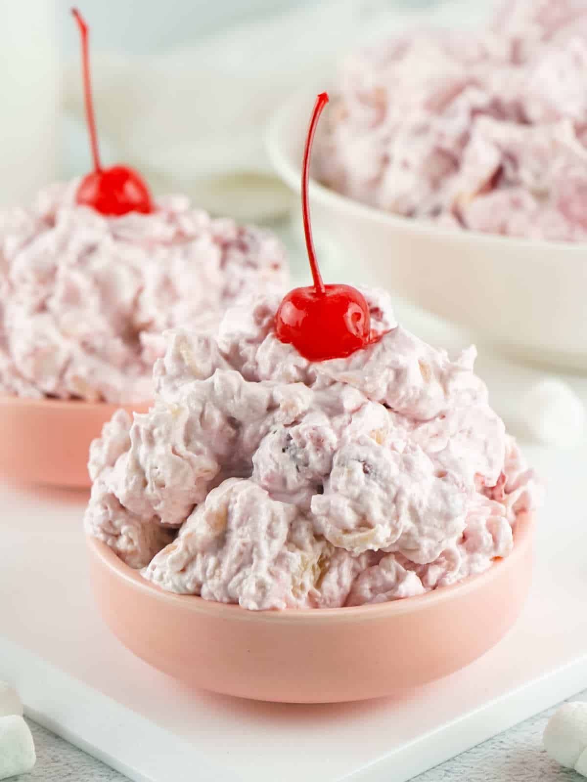 two pink serving bowls of Cherry fluff.